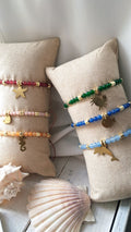 bracciali regolabili con pietre dure colorare e ciondoli vari