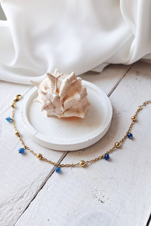 cavigliera dorata in acciaio dorato con pietre blu
