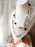 collana lunga con catena in acciaio, rettangoli in ottone e pietre dure, fatta a mano